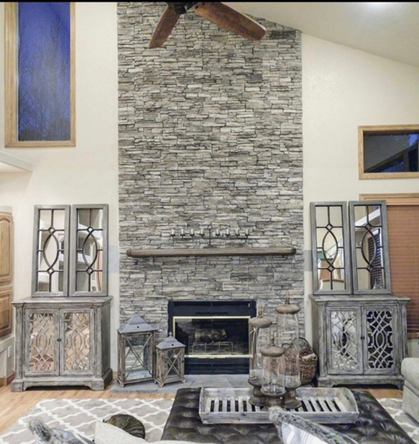 Floor-to-ceiling stacked-stone fireplace